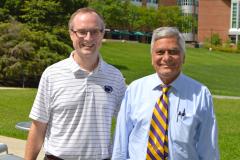 John Mauro, a glass expert and professor at Penn State, stands with his undergraduate adviser Arun Varshneya 