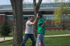 Marisa Ferger, a lecturer in meteorology, is hit in the face with a pie as part of a student fundraiser.